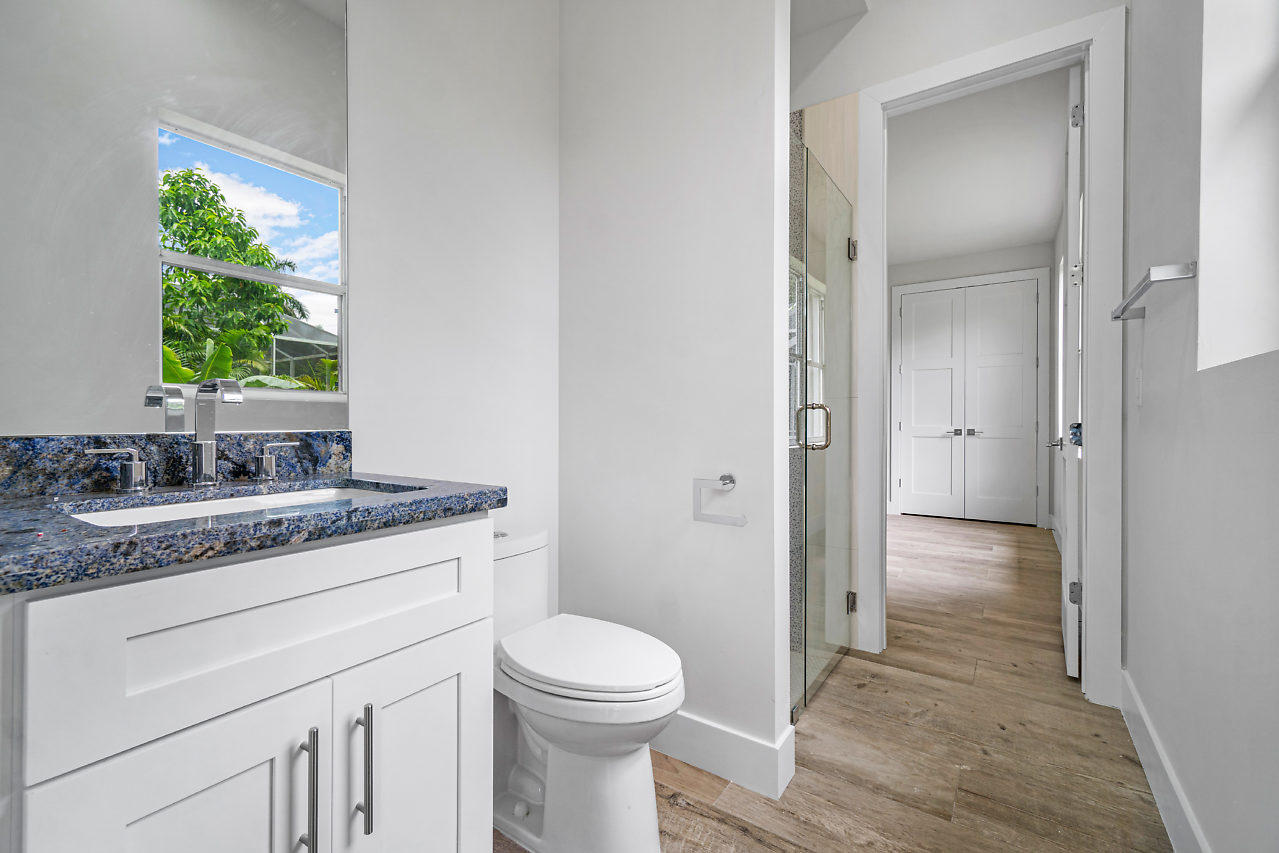 21311 Falls Ridge Way Boca Raton, FL 33428 - Photo 30 of 56 a bathroom with a granite countertop sink toilet and shower