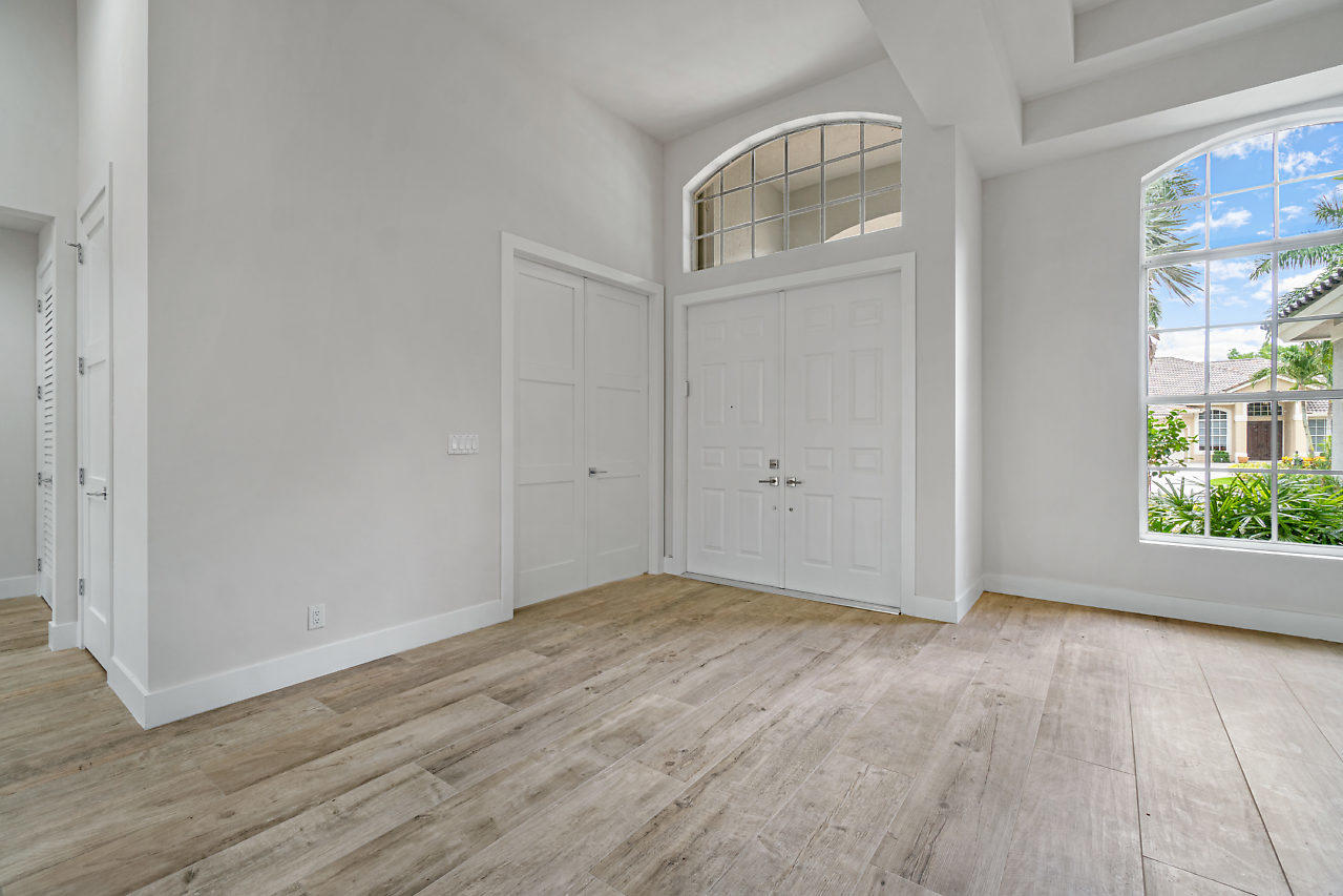21311 Falls Ridge Way Boca Raton, FL 33428 - Photo 5 of 56 a view of an empty room with wooden floor and a window