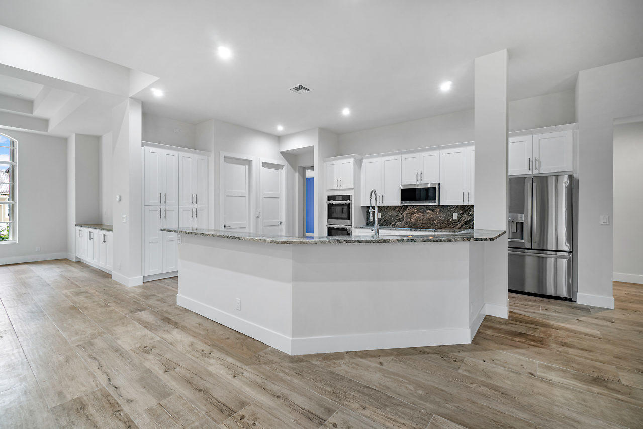 21311 Falls Ridge Way Boca Raton, FL 33428 - Photo 9 of 56 a kitchen with stainless steel appliances granite countertop a refrigerator sink and white cabinets