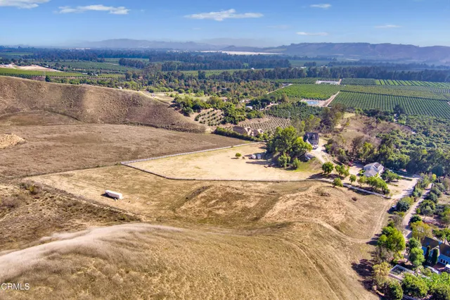 a view of a dry yard with mountains in the background