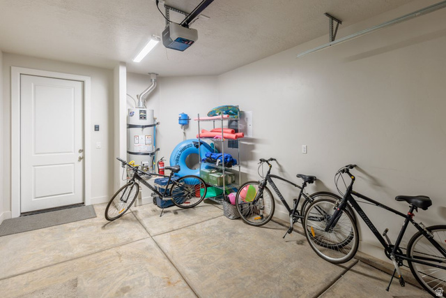 4845 Fishers Is Way St. George, UT 84770 - Photo 24 of 41 Garage featuring secured water heater and a garage door opener