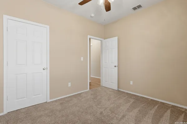 an empty room with a ceiling fan