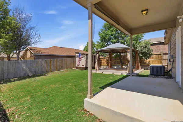 a view of a house with backyard and a sitting area