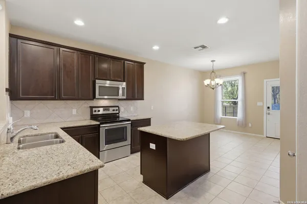 a kitchen with a sink stove and refrigerator
