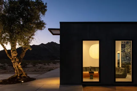 a living room with furniture and a floor to ceiling window