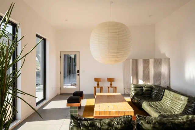 a bedroom with a bed and glass door