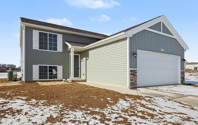 a front view of a house with a garage