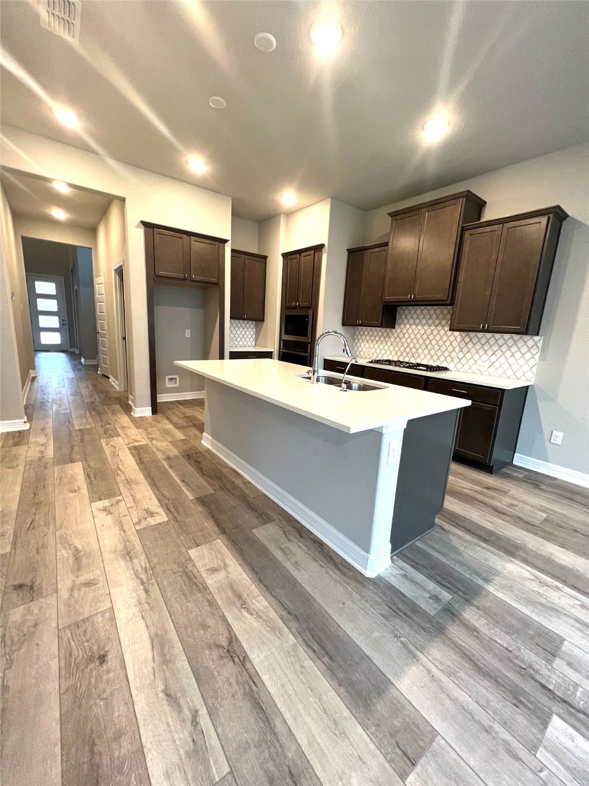 24239 Maple Summit Lane Katy, TX 77494 - Photo 2 of 17 a large kitchen with kitchen island a sink stainless steel appliances and cabinets