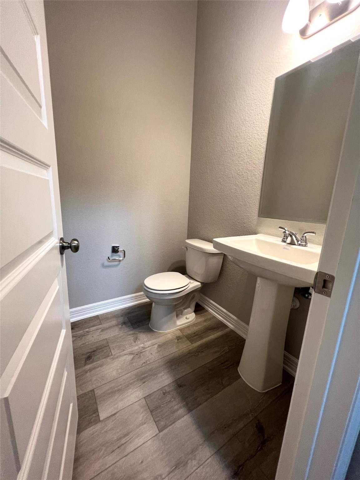 24239 Maple Summit Lane Katy, TX 77494 - Photo 10 of 17 a white toilet sitting next to a sink