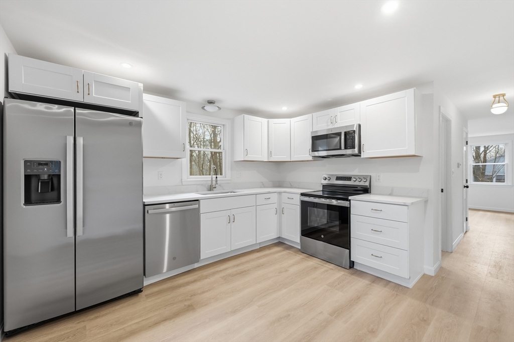18 Emery Road Townsend, MA 01469 - Photo 4 of 18 a kitchen with white cabinets and stainless steel appliances