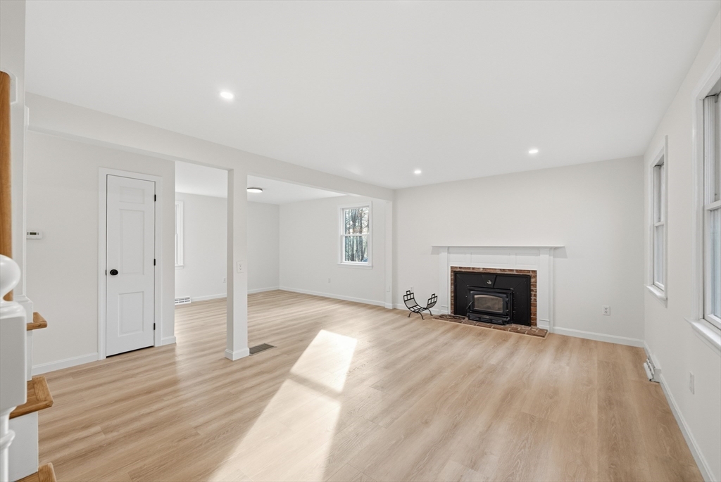 18 Emery Road Townsend, MA 01469 - Photo 6 of 18 a view of empty room with wooden floor and fireplace