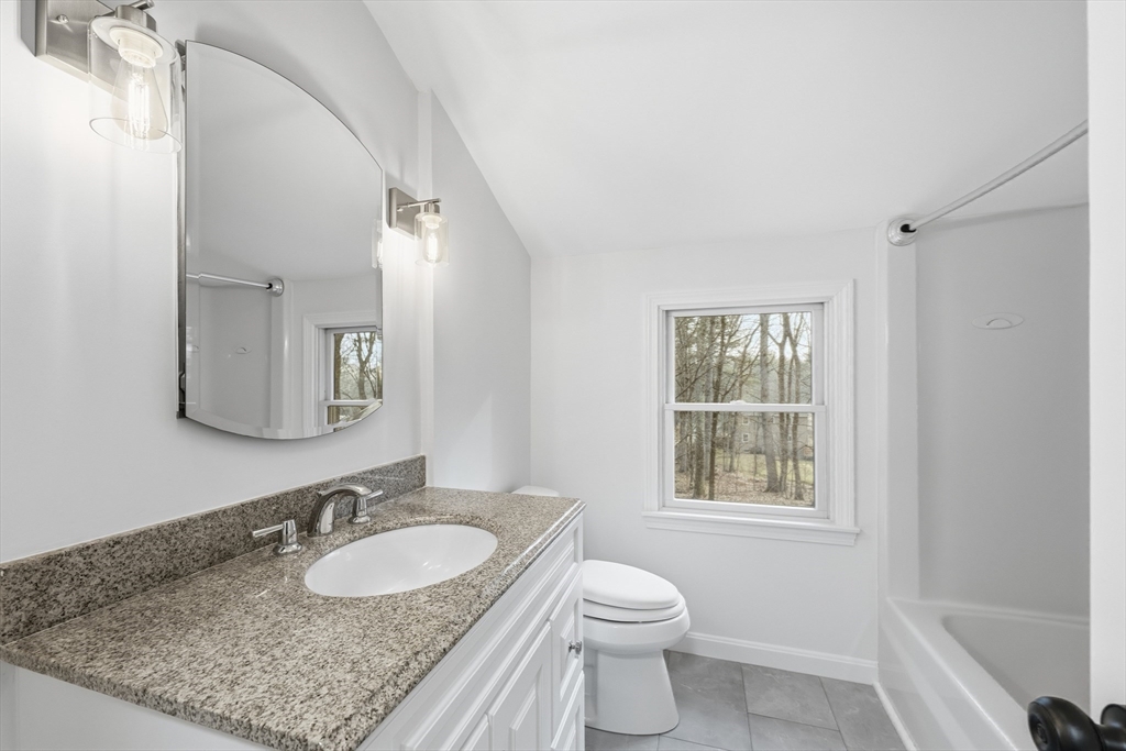 18 Emery Road Townsend, MA 01469 - Photo 10 of 18 a bathroom with a granite countertop sink and a mirror