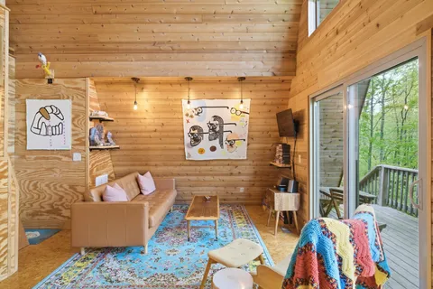 a living room with furniture and a floor to ceiling window
