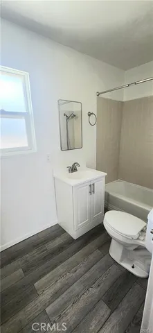 a white toilet sitting next to a bathroom sink