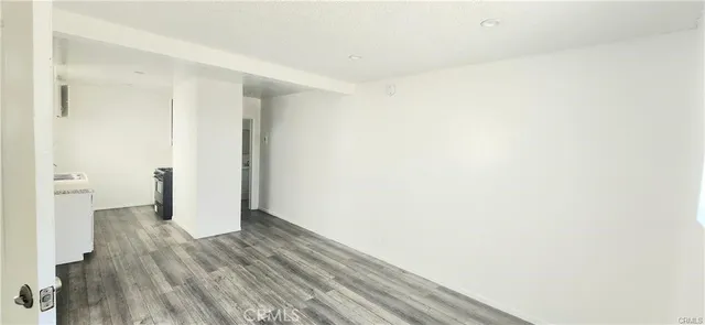 a view of a room with wooden floor