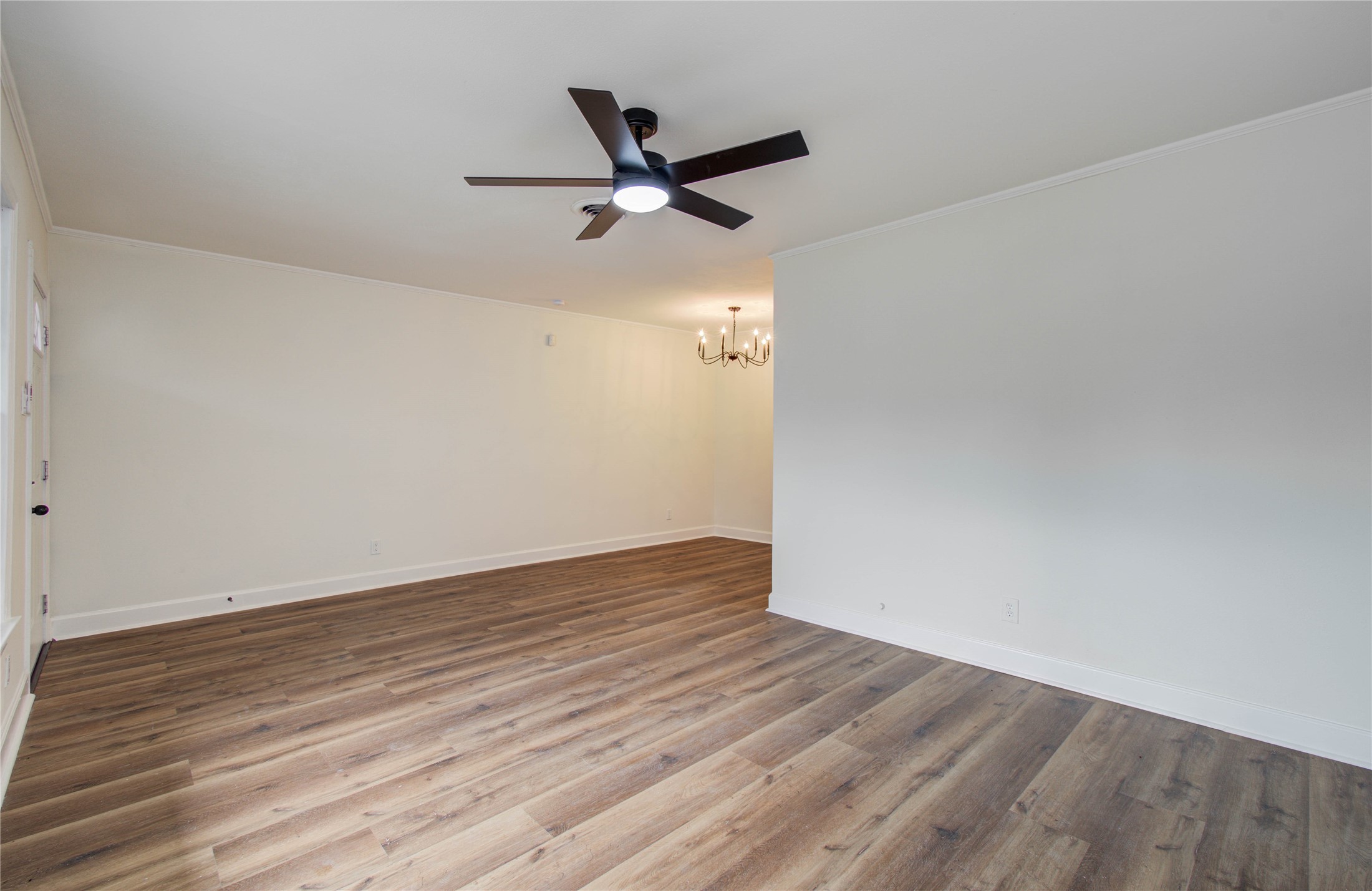 2417 Pecan Street Dickinson, TX 77539 - Photo 24 of 43 an empty room with wooden floor a ceiling fan and wooden floor
