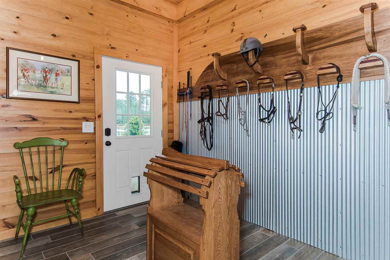 1522 Freedom Road Smithfield, NC 27577 - Photo 20 of 25 12’x12’ climate-controlled.HVAC wall unit; 8’ cabinetry; oversized sink w/hot/cold water; granite counters; custom made rack for 6 saddles & bridles, girths, whips; beverage refrigerator; tongue & groove 10’ walls & ceiling Tack Room