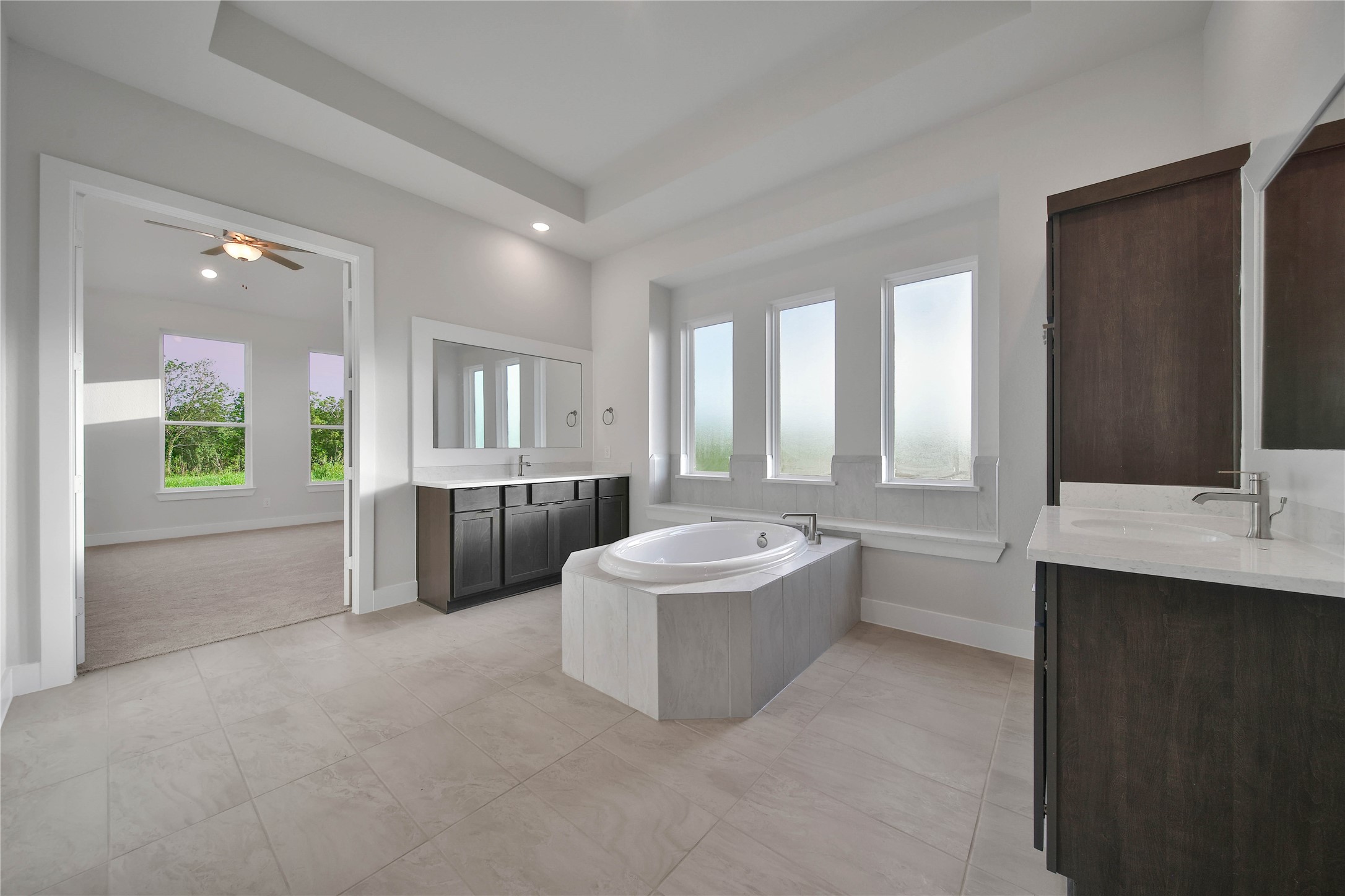 4602 Magnolia Bend Drive Rosharon, TX 77583 - Photo 18 of 39 a bathroom with a double vanity sink a mirror and a bathtub