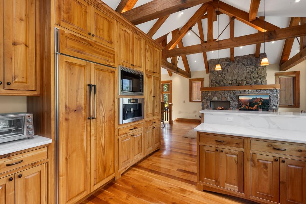 a kitchen with stainless steel appliances granite countertop a refrigerator and cabinets