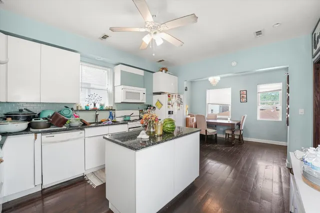 a kitchen with sink cabinets and wooden floor