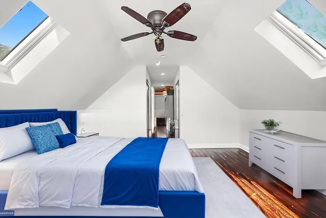 a bedroom with a bed and a ceiling fan