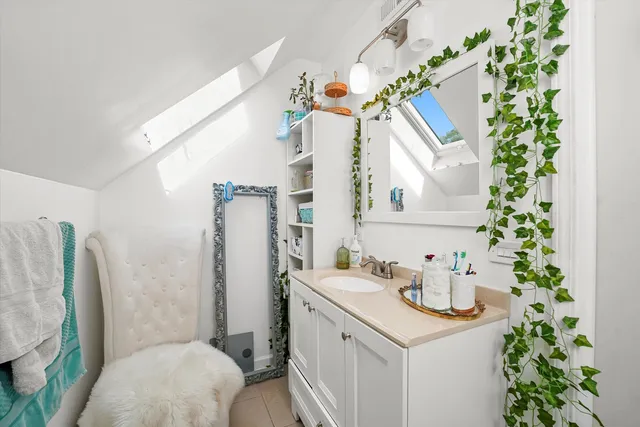 a bathroom with a sink and mirror with toilet