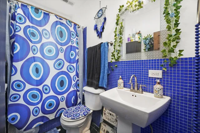 a bathroom with a sink a toilet and a mirror