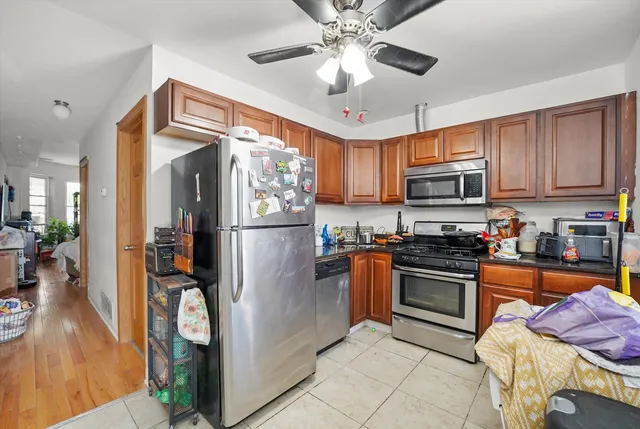 a kitchen with stainless steel appliances granite countertop a refrigerator a stove microwave and sink