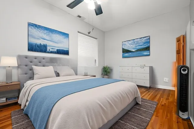 a bedroom with bed and a chandelier