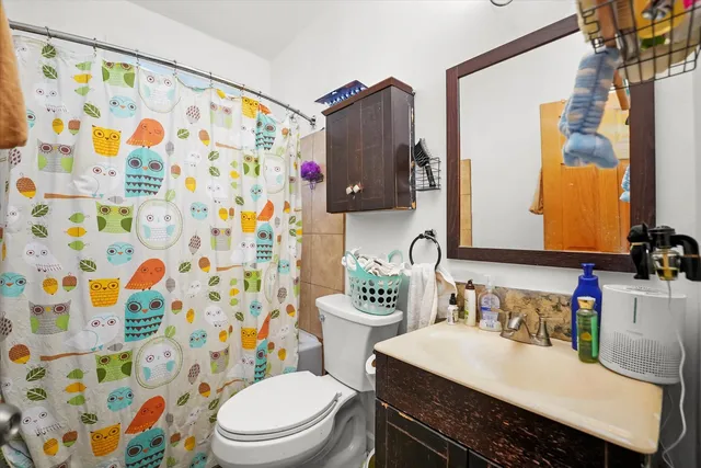 a bathroom with a sink toilet and shower