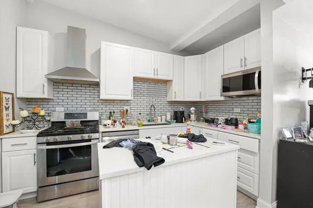 a kitchen with a stove a sink and a microwave