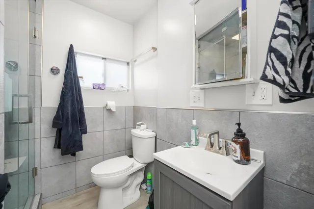 a white toilet sitting next to a bathroom sink