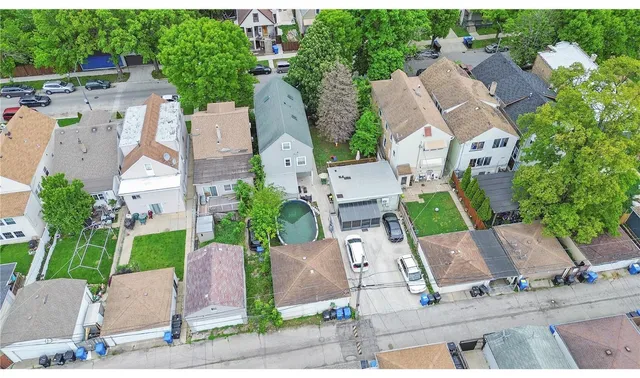 an aerial view of a house with garden space and street view