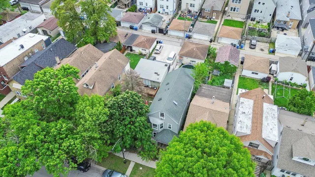 an aerial view of a house with a yard and garden