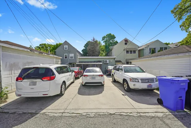 a view of a roof deck with table and chairs