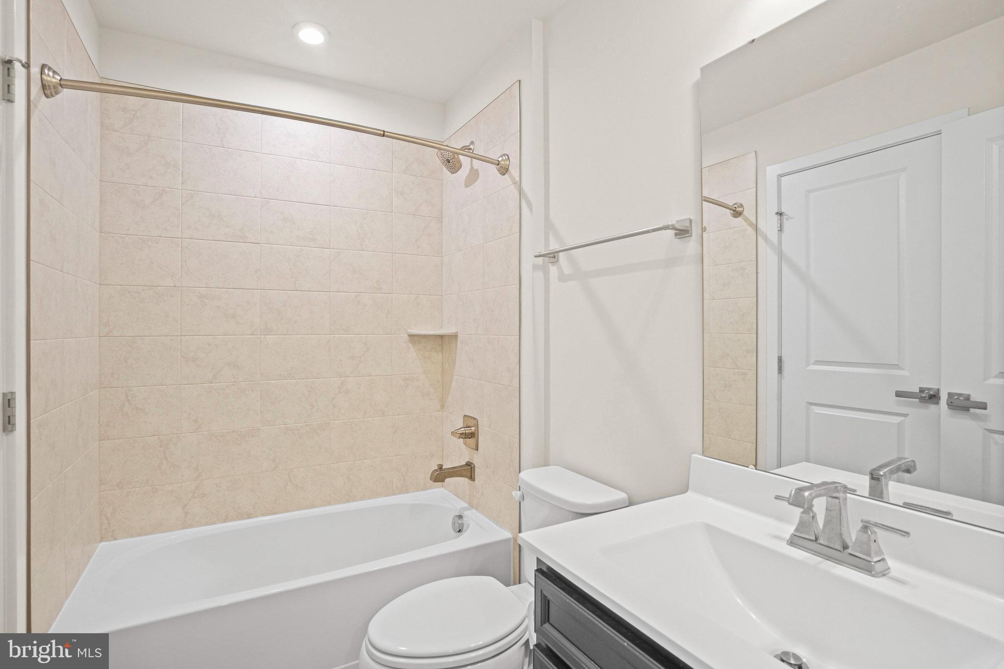 2808 Devonshire Cliffs Terrace Hyattsville, MD 20782 - Photo 13 of 19 a bathroom with a sink toilet and shower