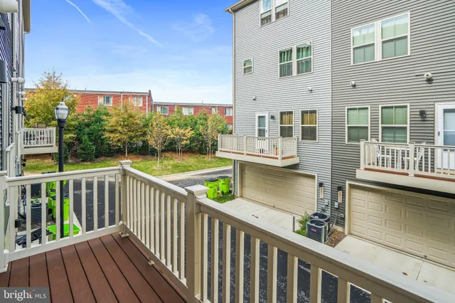 a view of a balcony with wooden floor and fence