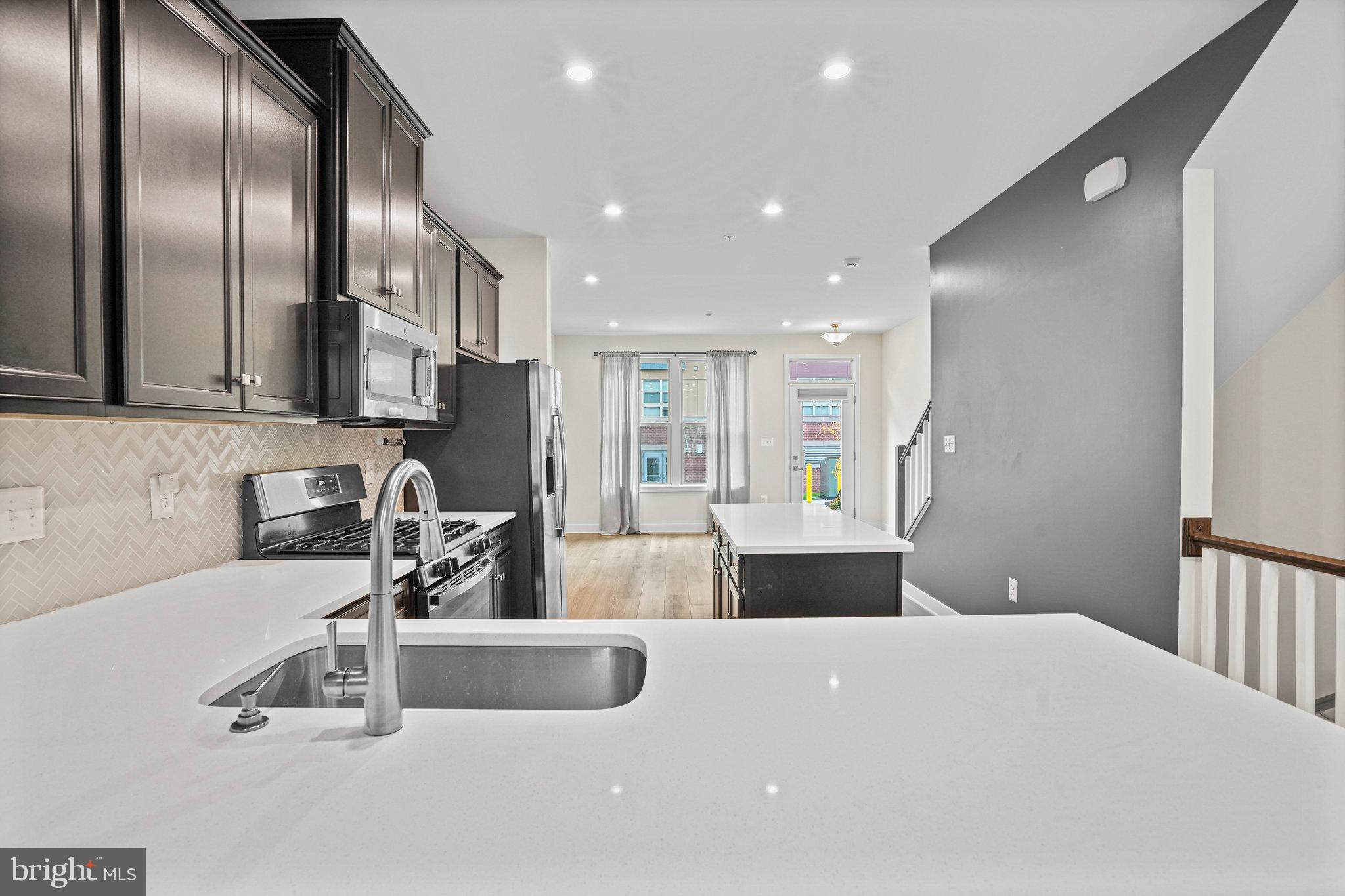 2808 Devonshire Cliffs Terrace Hyattsville, MD 20782 - Photo 3 of 19 a kitchen with stainless steel appliances a sink a stove and a refrigerator