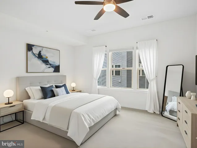 a bedroom with a large bed and a window