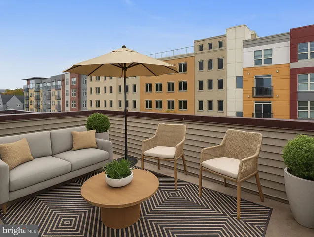 a balcony with table and chairs