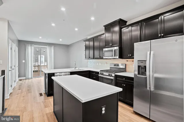 a kitchen with granite countertop stainless steel appliances cabinets and a counter top space