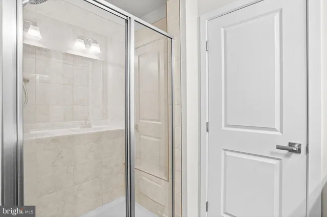 a bathroom with a glass shower door