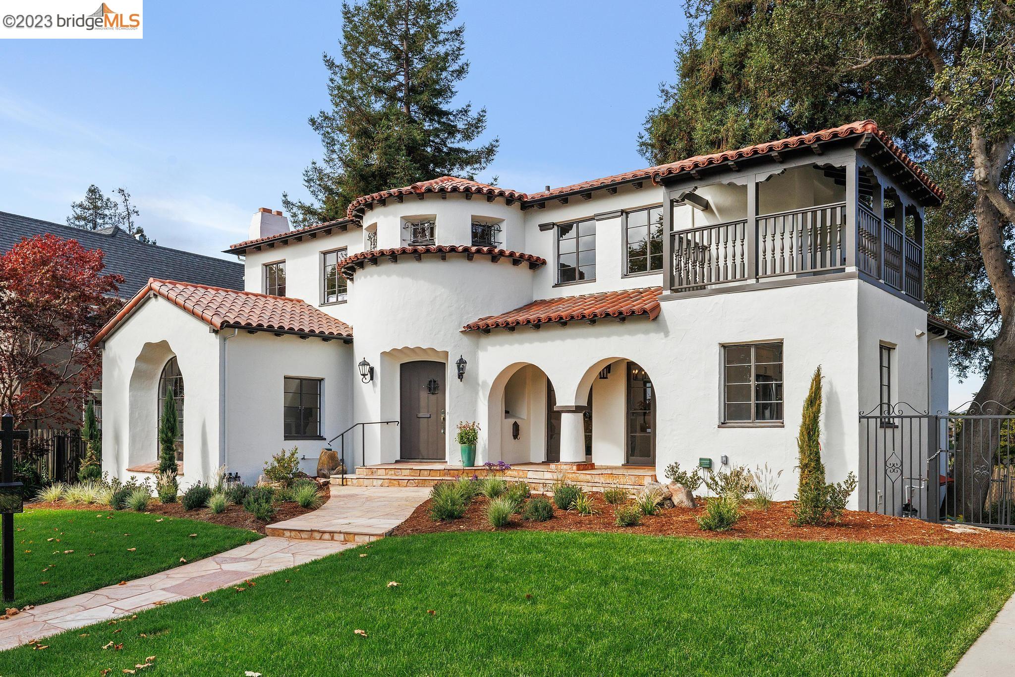a front view of a house with a garden and plants