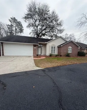 a view of a house with a yard and garage