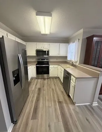 a kitchen with wooden cabinets and stainless steel appliances
