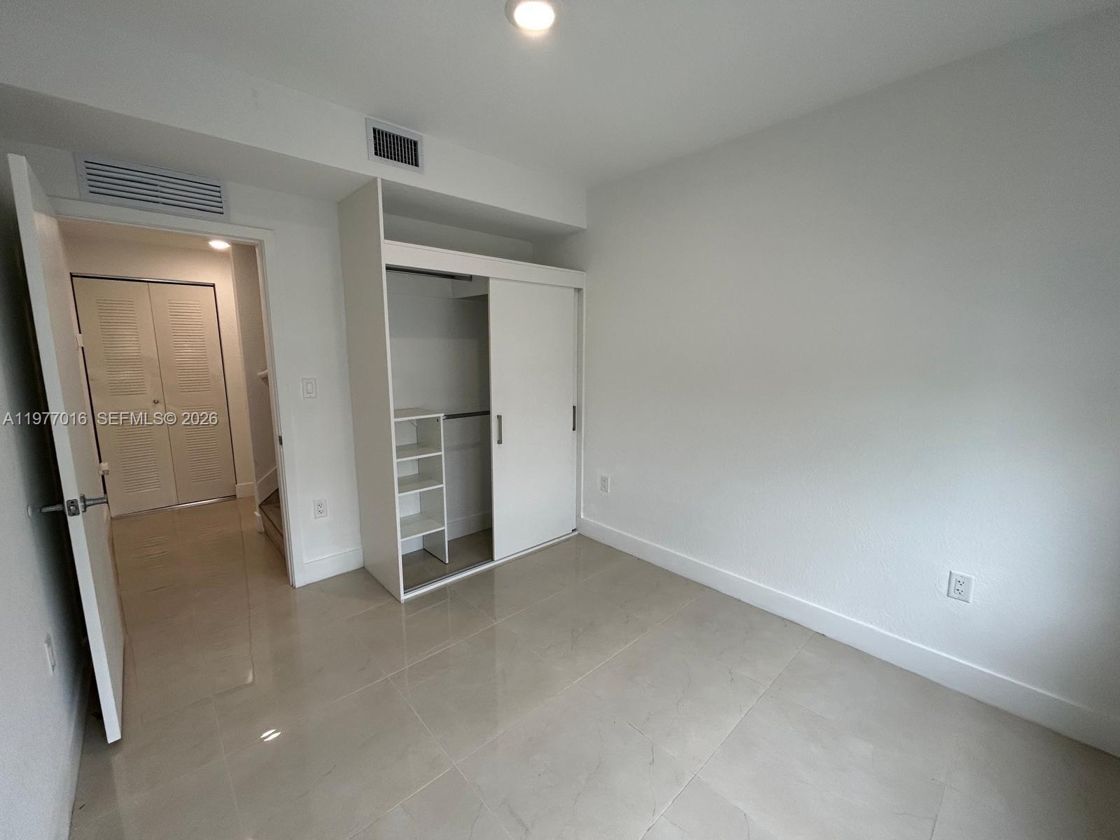 25814 Southwest 144th Court, Unit 2 Homestead, FL 33032 - Photo 15 of 25 an empty room with closet