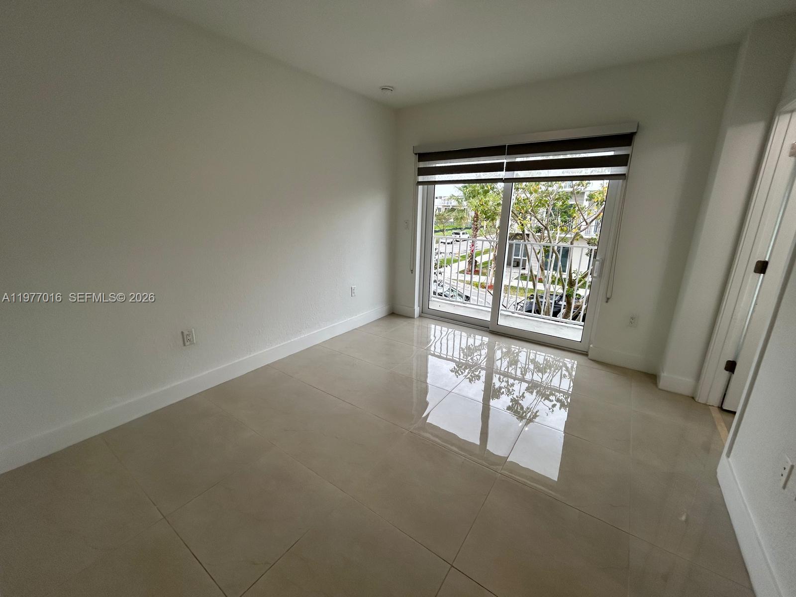 25814 Southwest 144th Court, Unit 2 Homestead, FL 33032 - Photo 17 of 25 a view of an empty room with a window