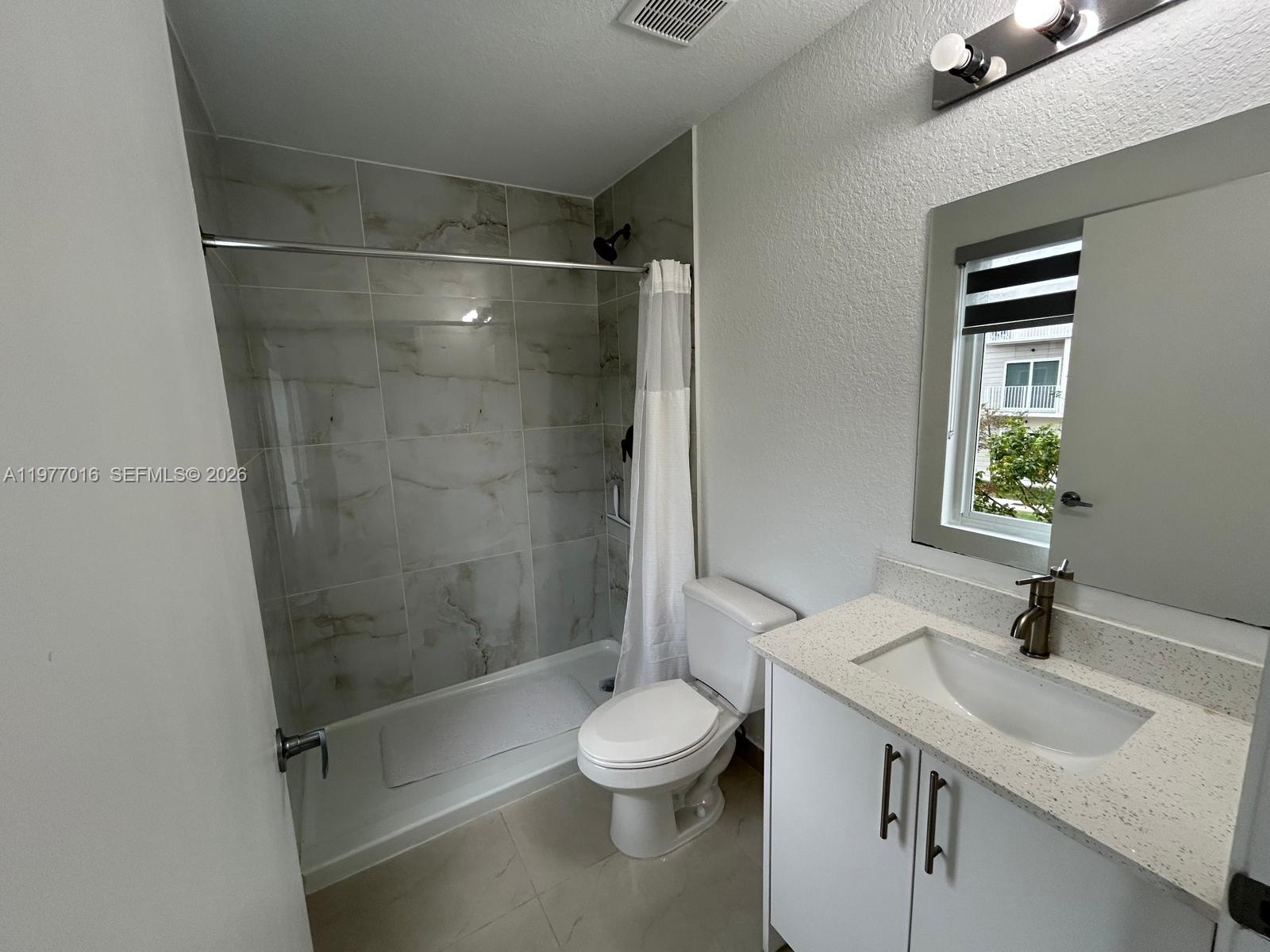 25814 Southwest 144th Court, Unit 2 Homestead, FL 33032 - Photo 19 of 25 a bathroom with a sink toilet and shower