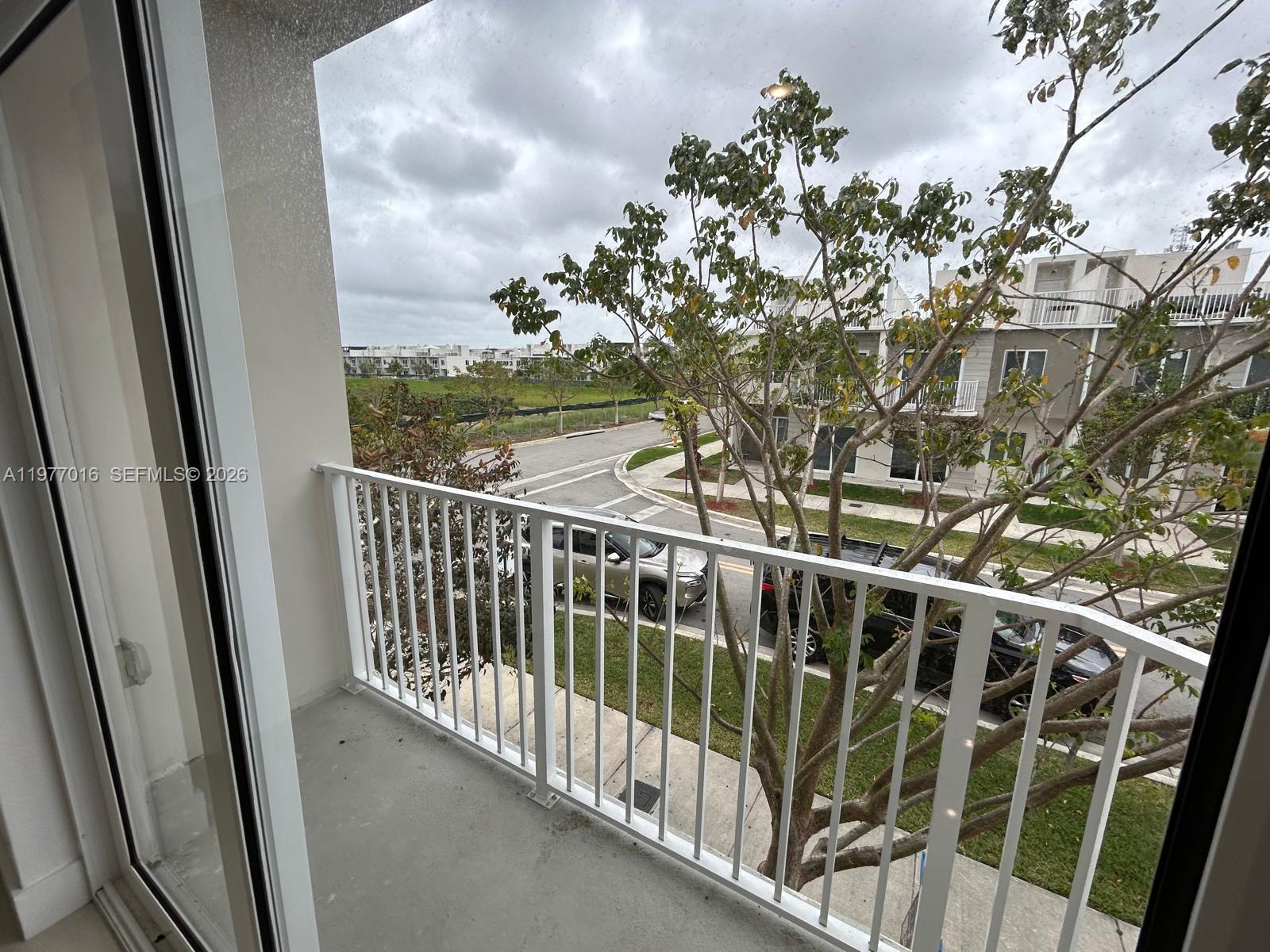 25814 Southwest 144th Court, Unit 2 Homestead, FL 33032 - Photo 20 of 25 a view of a balcony with wooden floor