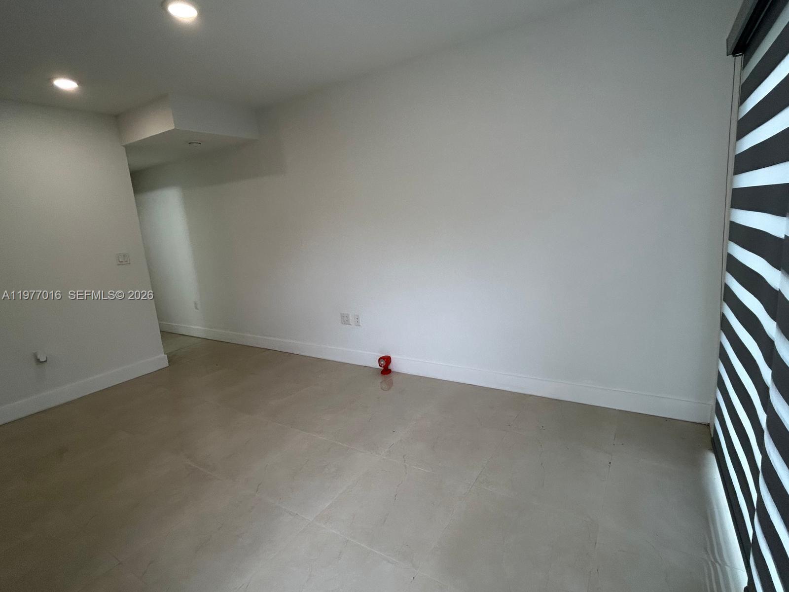25814 Southwest 144th Court, Unit 2 Homestead, FL 33032 - Photo 2 of 25 an empty room with windows